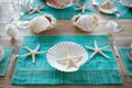 person setting a table with turquoise placemats, white starfish decorations, and shellshaped dishes