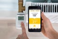 Person Setting Temperature Of Thermostat Using Mobilephone