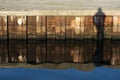 Person shadow on rusty pier