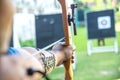 Man shooting with bow on a target during an archery. Royalty Free Stock Photo