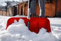 Person shoveling snow outdoors on winter day, closeup