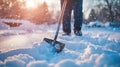 a person shoveling snow from a sidewalk Royalty Free Stock Photo