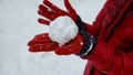 Person showing snowball to camera, winter entertainment, playing active games