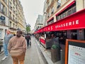 person on sidewalk paris street and bar cafe terrace