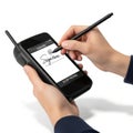 Person signing a digital document on a handheld device with a stylus isolated on white background Royalty Free Stock Photo