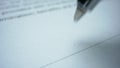 Person signing document with pen. Ballpen making signature on business paper