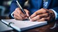 person signing a document, person writing on a notebook, close-up of bussinessman hand writing on a notebook with pen Royalty Free Stock Photo