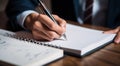 person signing a document, person writing on a notebook, close-up of bussinessman hand writing on a notebook with pen Royalty Free Stock Photo