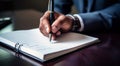 person signing a document, person writing on a notebook, close-up of bussinessman hand writing on a notebook with pen Royalty Free Stock Photo