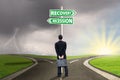 Person with signpost of recession and recovery finance Royalty Free Stock Photo