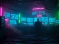 Lone figure in a dimly lit futuristic control room with multiple glowing computer screens and neon lights Royalty Free Stock Photo