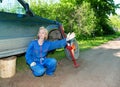 The person sits having leaned against the car Royalty Free Stock Photo