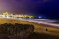 person sitting on the beach at night in biarritz france. Europe Royalty Free Stock Photo