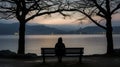 a person sitting on a bench looking out over a body of water Royalty Free Stock Photo