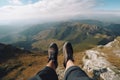 A person is sitting on a cliff with stunning view on mountains. Generative ai