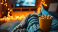 A person sitting on a couch with their feet up and holding a cup of popcorn, AI Royalty Free Stock Photo