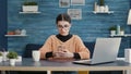 Person sitting at desk and using smartphone to browse internet Royalty Free Stock Photo