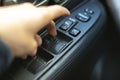 a person sitting inside the car and open the window, finger push the button Royalty Free Stock Photo