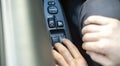 a person sitting inside the car and open the window, finger push the button Royalty Free Stock Photo