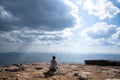 A person sitting on rocky mountain looking out at scenic natural view Royalty Free Stock Photo