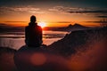 person, sitting in silent meditation, with view of beautiful sunset
