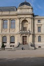 A person sitting on stairs of National Museum of Natural History at Garden of Plants in Paris Royalty Free Stock Photo