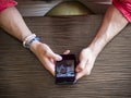 Photo of a person using a cellphone at a table Royalty Free Stock Photo