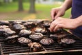 person skewering portobello mushrooms for grilling