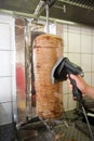 Person slicing kebab meat