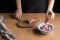 A person slicing pork tenderloin for making a meal Royalty Free Stock Photo