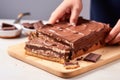 person spreading nutella on a slice of bread