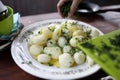 Person sprinkles potatoes with herbs