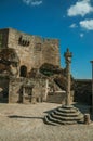 Person on square with pillory in front of stone castle Royalty Free Stock Photo