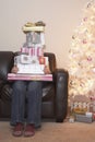 Person With Stack Of Christmas Gifts On Sofa Royalty Free Stock Photo