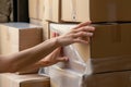 person stacking boxes, hands blurred while arranging them