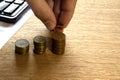 Person Stacking Coins With Calculator On Wooden Desk Royalty Free Stock Photo