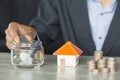 A Person Stacking Coins Near House On Wooden Desk. Property Tax Royalty Free Stock Photo