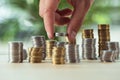 Person stacking coins on table, investment concept Royalty Free Stock Photo