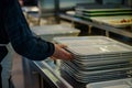 person stacking trays in canteen selfservice area Royalty Free Stock Photo