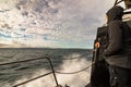 Person standing on boat looking at the ocean on Svalbard Royalty Free Stock Photo