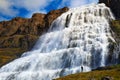 Person standing at the Dynjandi waterfall on the Westfjords peninsula in Iceland