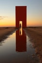 A person standing in front of a red structure. Generative AI image.