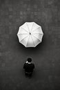 Person standing in front of wall with umbrella. Generative AI Royalty Free Stock Photo