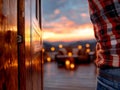 A person standing in front of a wooden door with a sunset in the background Royalty Free Stock Photo