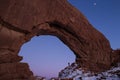 Person standing in North Window arch at night in Winter