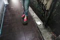 Person standing on skateboard in streetside alley Royalty Free Stock Photo