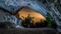 Person standing under the rocks surrounded by trees during the evening - cool for backgrounds