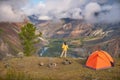 Person stands near the camping and look at the view valley.