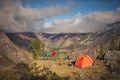 Person stands near the camping and look at the view valley