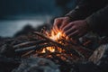 A person is starting a campfire with sticks and a flame Royalty Free Stock Photo